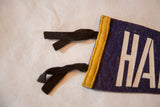 Black felt ties, yellow trim, and white HA lettering on vintage Halifax pennant.