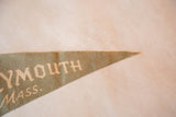Muted green felt flag tip, showing partial 'YMOUTH MASS.' text and worn edge.