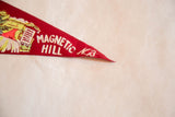 Close-up of the white lettering and felt texture on the vintage red pennant tip.