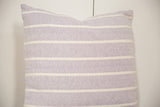 Angled close-up of the hand-woven lavender striped pillow, showing its unique texture and white bands.