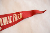 Close-up of vintage 1950s red felt pennant, showing creamy 