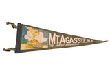 Vintage dark green Mt. Agassiz felt pennant with gold-picking fist and train scene.