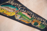 Vintage dark blue felt pennant section with 'The Lodge' graphic and cream lettering.