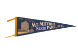 Vintage Mt. Mitchell State Park, NC pennant, dark blue felt with yellow tower graphic.