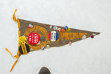 Pointed tip of vintage felt pennant showing 'PREPARED' text and political campaign pins.