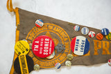 Assortment of vintage 1960s Republican and Oklahoma University pins on a worn felt flag.