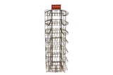 Mid-century Bantam Books industrial metal display rack with tiered slots and red sign.