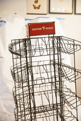 Upper section of the vintage industrial metal Bantam Books display rack with red sign.