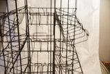 Blurred dark metal grid and shelving of the Bantam Books industrial display rack.