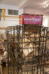 Aged dark metal wire shelving of the Bantam Books display rack.