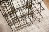 Industrial dark metal wire construction of the Bantam Books display rack.