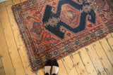 Frayed fringe and worn border detail on antique Malayer rug.