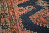 Serrated faded brick red border and antique ivory panel on a Fine Malayer rug.