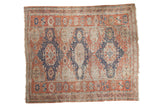 Antique hand-woven Caucasian Soumac carpet with bold navy geometric medallions on a madder red field.