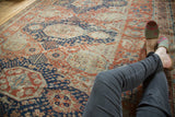 Antique Caucasian Soumac carpet displays geometric medallions and rectilinear designs in madder red and navy.