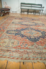 Geometric madder red and navy border with light tatter on antique Soumac rug end.
