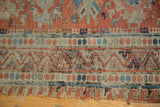 End detail of an antique Caucasian Soumac flatweave rug, intricate terracotta and blue geometric patterns.
