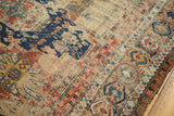Antique Soumac rug's red, blue, and ivory geometric motifs with visible foundation.