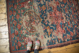 Early 20th century Caucasian Soumac rug, faded green field with worn texture and asymmetric motifs.
