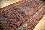 Antique Kurdish Malayer runner with intricate repeating boteh paisley motifs in indigo and madder red.