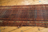 Antique Kurdish Malayer runner end with indigo blue, madder red boteh, and tattered selvage.