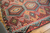 Antique Turkish Kilim corner, tattered fringe, hook and latch motifs in red, blue, gold.