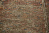 Worn pile and exposed foundation of an Antique Belouch rug with madder red and navy blue tones.