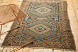 Vintage Caucasian rug, lower right corner, worn fringe, geometric border, intact selvage.
