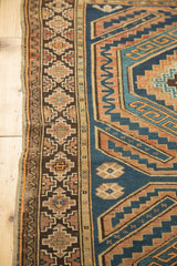 Geometric border of a hand-knotted vintage Caucasian rug with navy blue and copper tones.