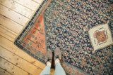 Hand-knotted antique Persian rug showcasing a navy Herati field and ivory pomegranate medallion.