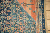 Fine meshed antique Persian rug fragment corner, navy Herati design, terracotta tones.