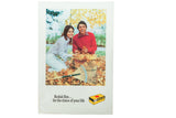 Vintage 1970s Kodak film ad showing a couple smiling in colorful autumn leaves.