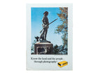 Vintage Kodak advertisement print featuring the Minuteman Monument in Concord against a clear blue sky.