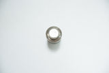 Top view of antique dental tin's round cap with metallic, aged finish.