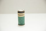 Vintage Albodon Dental Tin, dark green with white polka dots and aged metal cap.