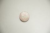 Clear top view of antique Eycryl Dental Tin, with red and cream snake graphics.