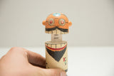 Hand separating vintage Dentist Popsie toy to show 'SAY AAH!' and side ax.