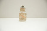 Close-up of the antique Colgate Dental Powder jar's aged label and original embossed lid.