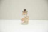 Aged paper label with 'Antiseptic Dental' text on antique Colgate jar.