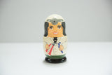 Hand-painted dentist doll, showing white coat, grey head mirror, toothpaste, and brush.