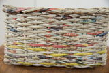 Close-up of the woven texture of vintage Japanese newspaper strips, showing colorful text.