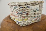 Woven vintage Japanese newspaper basket showcasing printed text and colorful accents.