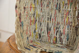 Interior close-up of a Vintage Japanese Newspaper Basket showing woven strips with text and varied colors.