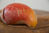 Vintage chili pepper piggy bank with chipped red-orange finish and visible coin slot.
