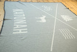 Light grey Katonah NY blanket with white vertical text and quadrant icons.