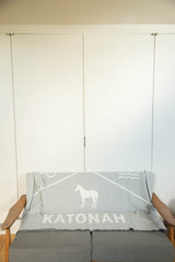 Katonah NY blanket featuring white horse, text, mountain, and wave motifs.