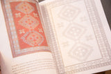 An open page of the coloring book showing a colored geometric rug next to its uncolored outline.