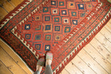 Antique Caucasian rug, geometric diamond field, reciprocating wave motif borders, and rich aged tones.