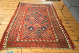 Antique Caucasian rug, geometric paneled diamond lattice and striking reciprocating wave borders.