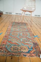 Antique Heriz rug fragment with serrated leaves, palmettes, sky blue, and madder root red.